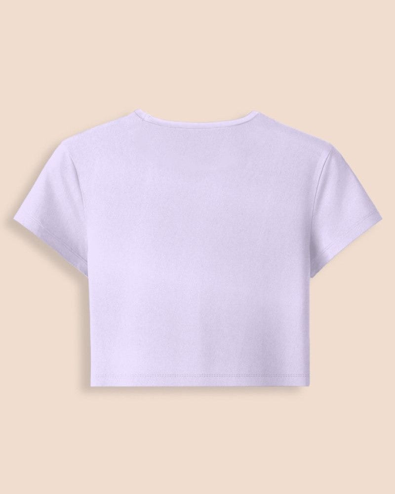 A light lavender short-sleeve crop top shown from the back, centered on a solid pale beige background.