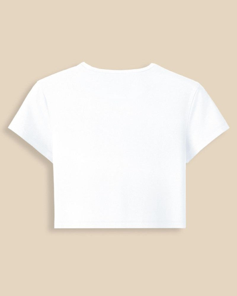 A white short-sleeve crop top t-shirt shown from the back, centered on a solid beige background.