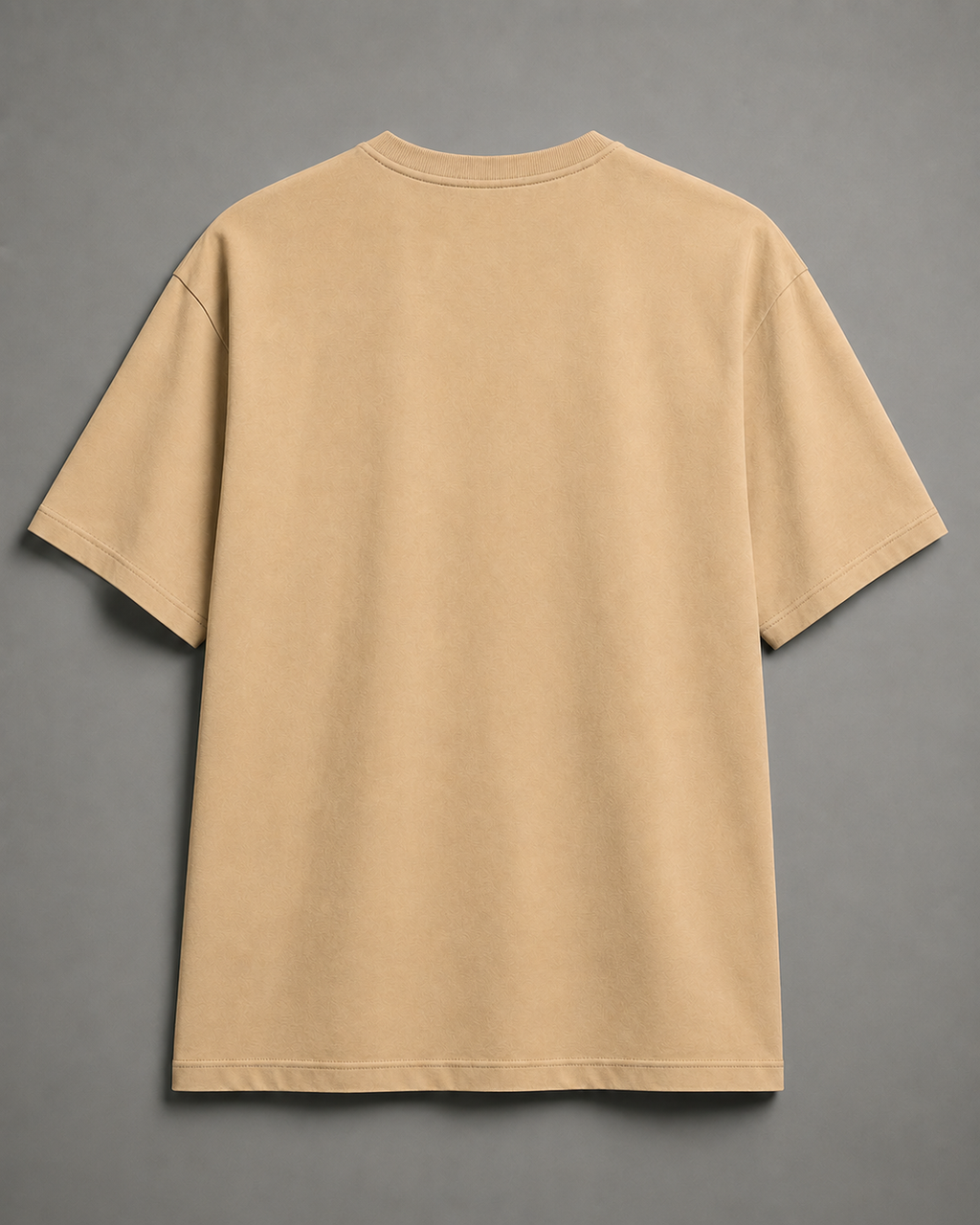 A plain beige short-sleeve t-shirt shown from the back, laid flat against a neutral gray background.