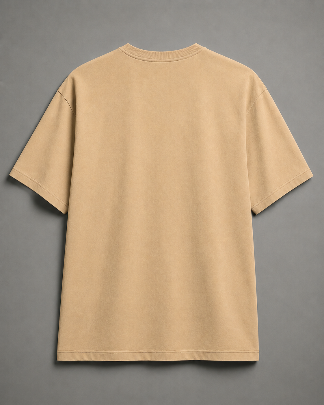 A plain beige short-sleeve t-shirt shown from the back, laid flat against a neutral gray background.