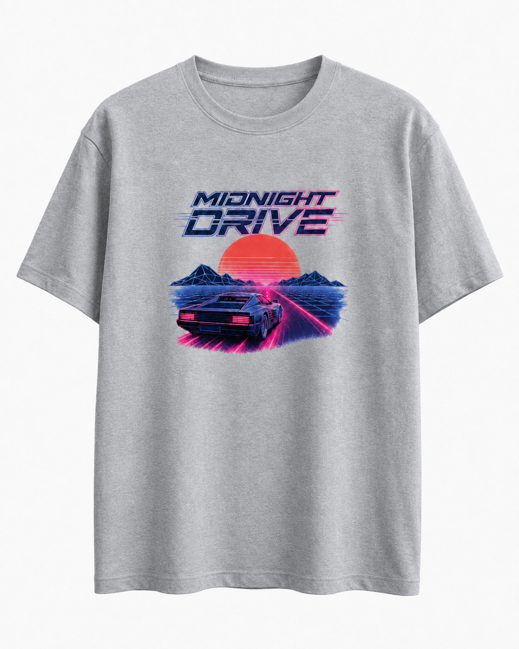 A light gray heather crewneck t-shirt featuring a retro 80s synthwave graphic with the text 'MIDNIGHT DRIVE' above a car, mountains, and a large orange sun.