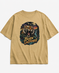 A tan crewneck t-shirt featuring a large graphic print of a roaring tiger and the text 'BORN UNTAMED' on the front, displayed against a light gray background.