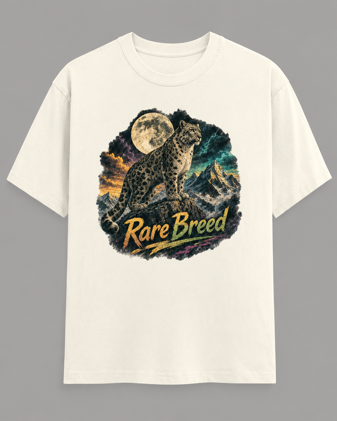 An off-white short-sleeve crewneck t-shirt featuring a circular graphic print of a snow leopard under a full moon with the text 'Rare Breed' in yellow, displayed against a solid gray background.