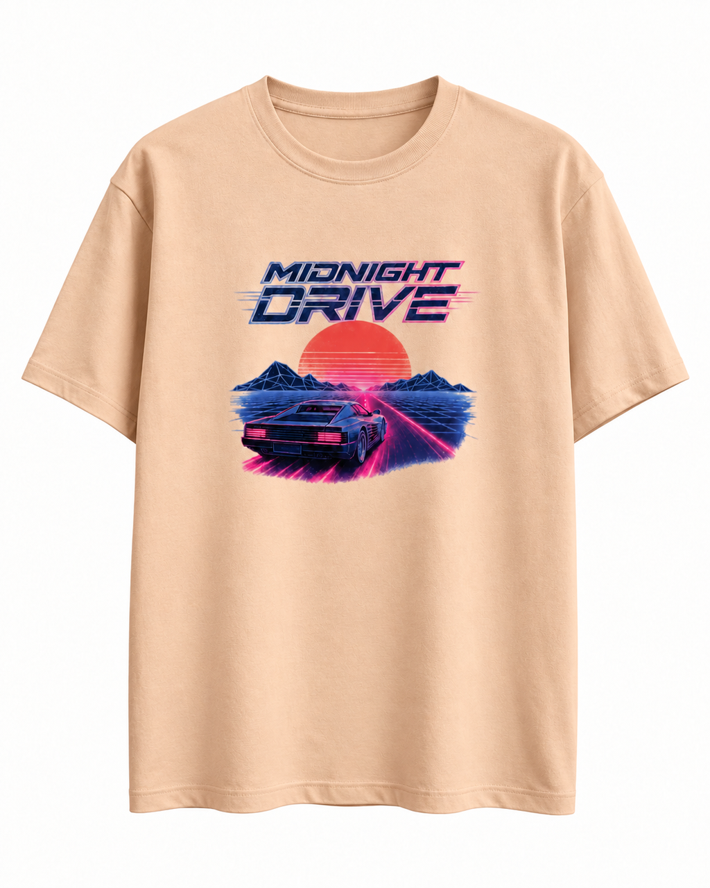 A light peach-colored short-sleeve t-shirt with a retro 80s synthwave graphic on the chest. The graphic features the text 'MIDNIGHT DRIVE' above a car driving on a neon pink road with a large orange sun and blue mountains in the background.