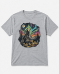 A heather gray short-sleeve crewneck t-shirt featuring a large graphic print of a howling wolf in a mountain landscape under a full moon and colorful aurora borealis, with the text 'Into the Wild' printed below.