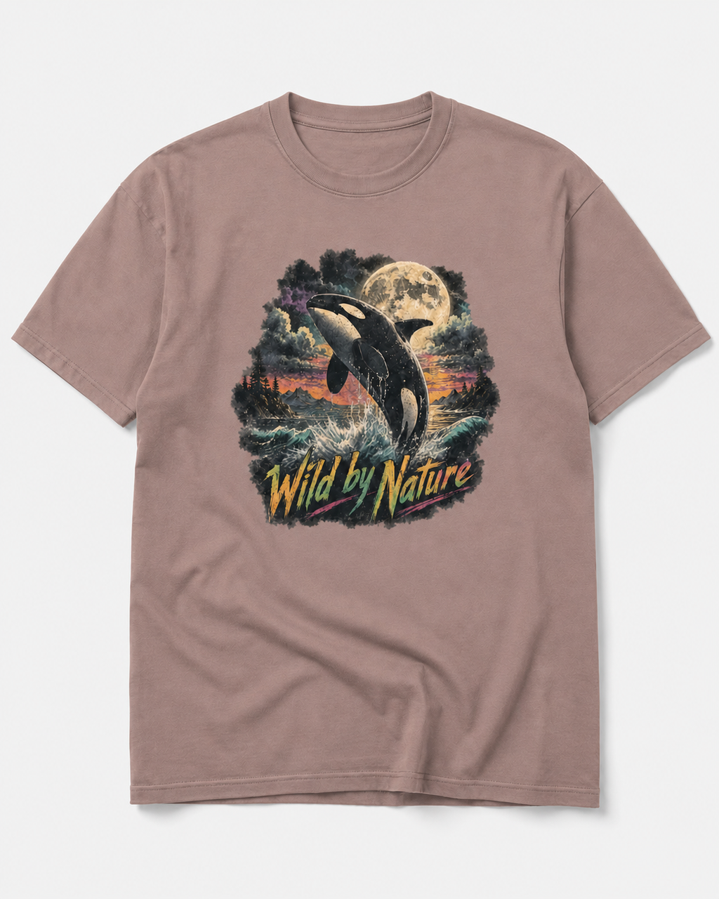 A dusty rose short-sleeve t-shirt with a large graphic print of an orca whale jumping out of the water under a full moon, with the text 'Wild by Nature' written below in yellow and green.