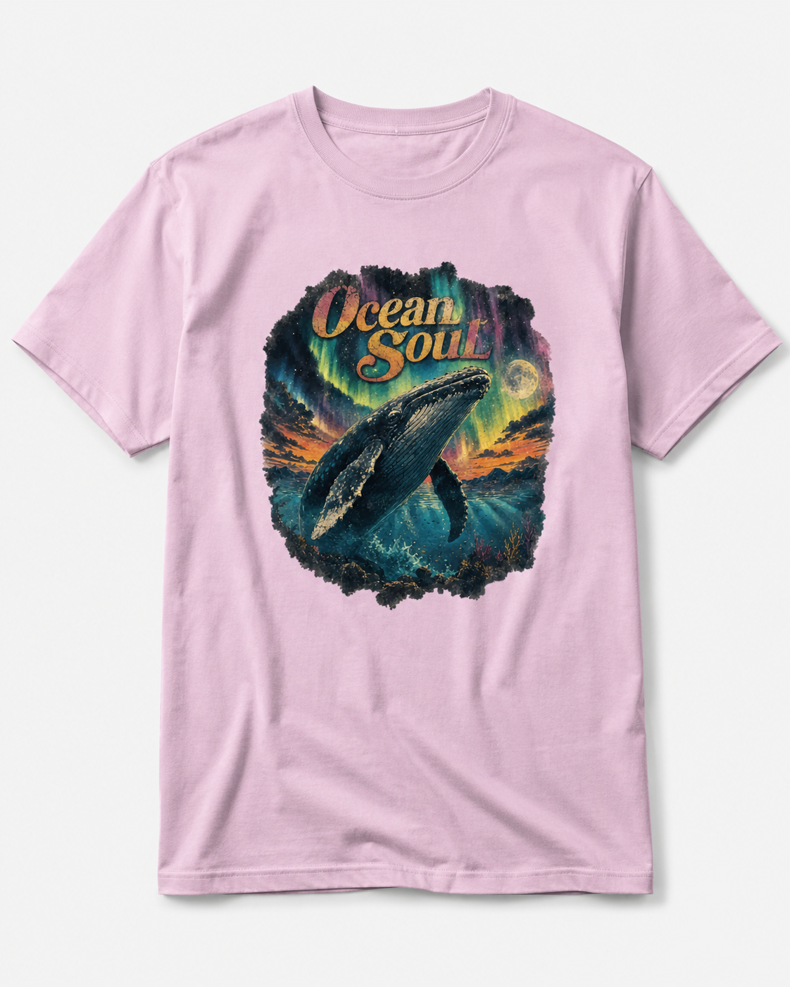 A light pink short-sleeve t-shirt with a colorful graphic print on the front featuring a whale, aurora lights, and the text 'Ocean Soul'.